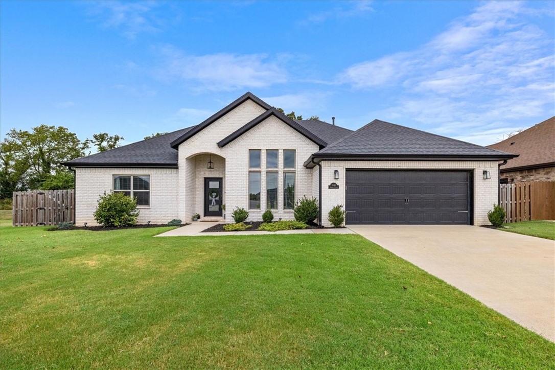 This stunning all-brick home combines timeless craftsmanship with modern elegance and located within 10 minutes to Downtown Bentonville. The open kitchen and living area is designed for both style and function, showcasing a grand island, gleaming granite countertops, and premium stainless steel appliances. The primary suite is a true retreat, featuring a spa-inspired bathroom with a walk-in shower and a free-standing soaking tub. Outside, an expansive backyard and covered patio with a striking outdoor fireplace create the perfect setting for sophisticated entertaining or serene relaxation. Schedule your showing now!