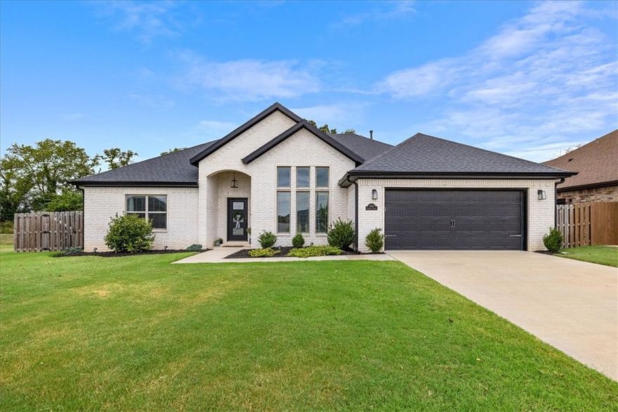 This stunning all-brick home combines timeless craftsmanship with modern elegance and located within 10 minutes to Downtown Bentonville. The open kitchen and living area is designed for both style and function, showcasing a grand island, gleaming granite countertops, and premium stainless steel appliances. The primary suite is a true retreat, featuring a spa-inspired bathroom with a walk-in shower and a free-standing soaking tub. Outside, an expansive backyard and covered patio with a striking outdoor fireplace create the perfect setting for sophisticated entertaining or serene relaxation. Schedule your showing now!