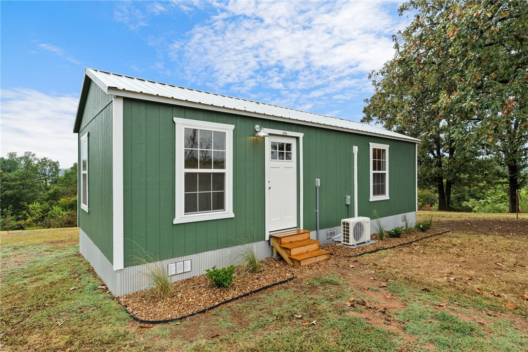Discover this unique 2-acre property just minutes from Booneville Lake and a short drive to Greenwood, Ft. Smith, and Mt. Magazine State Park. The centerpiece is a new 448 sq ft studio cabin on concrete piers with luxury vinyl plank flooring, Samsung SmartThings range, Rheem water heater, and mini-split HVAC for year-round comfort. Enjoy sunrise and sunset views from the deck in a peaceful, unrestricted setting—ideal for homesteading, a weekend getaway, or an Airbnb. Property includes a 33 ft RV pad with full hookups plus two septic systems: one for the cabin and a new 4BD system for future builds. Fiber optic internet, public water, and electric service are in place. Abundant wildlife, blackberries, valley and hilltop views add to the appeal. Whether you want to downsize, invest, or build, this property offers endless potential. Seller open to conventionally financed offers.