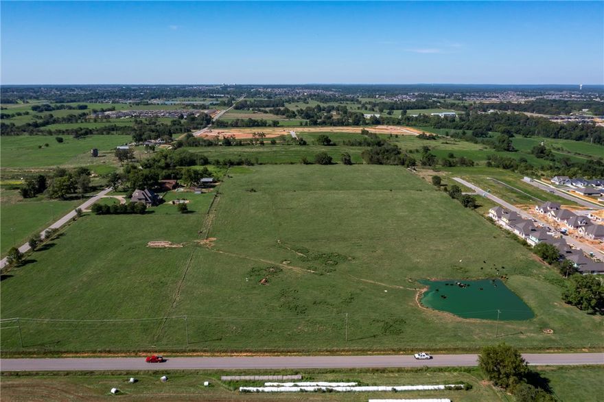 27.08 +/- acres of flat, cleared land w/ pond in Benton County w/ a Bentonville address but not annexed in to the city of Bentonville.