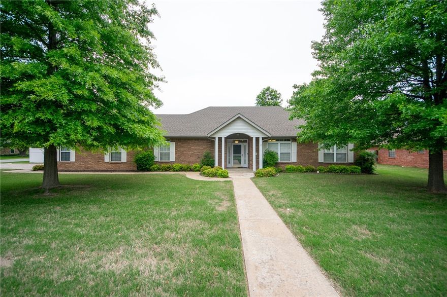 Imagine sitting in your heated and cooled sunroom after walking down the street to Starbucks to get your morning coffee. This beautiful well-kept and fully bricked home offers that opportunity and it sits on a large .48 acre corner lot. This 3 bedroom, 2 bath home has a formal dining room, the sunroom mentioned previously, and an additional 2 car fully bricked oversized garage. Home is located close to schools, Walmart Neighborhood Market, and a short drive to I-49 and the U of A. Seller has a current home warranty that conveys with the home and expires at the end of 2027.