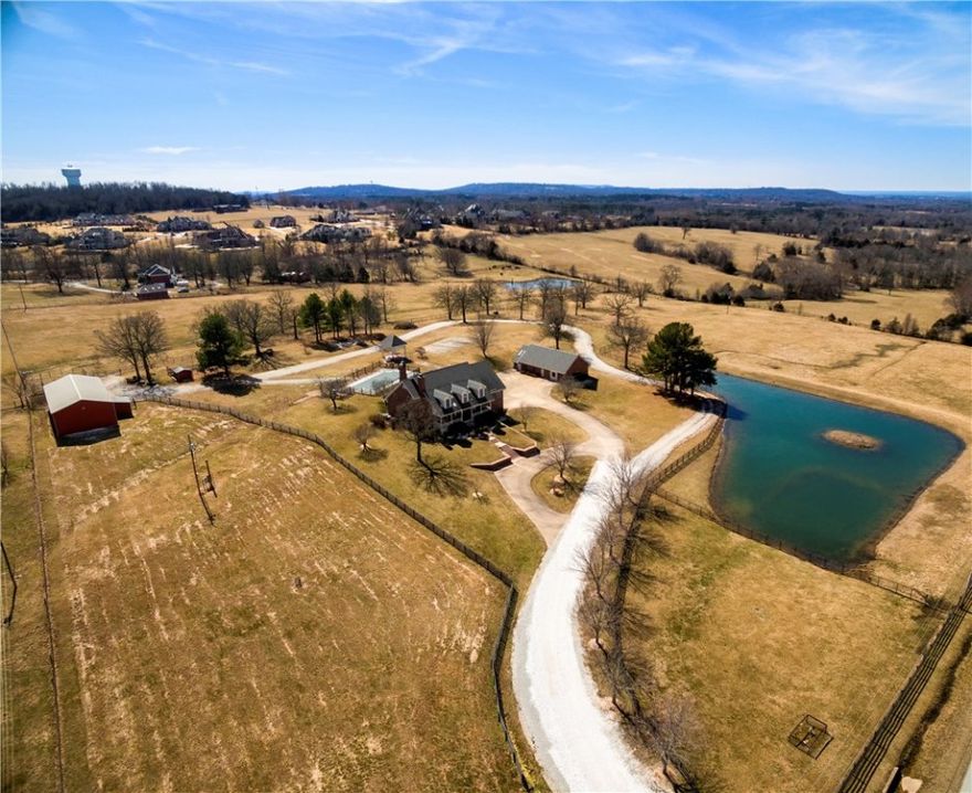 Country-feel gated oasis awaits. Endless potential. Relax on the front porch overlooking an island pond, feed the chickens or go fishing in the stocked pond! Custom-built one-owner home. Offers 5.62 for $799k or 20 acres. You choose! Updates include new AC unit upstairs,new furnace on main floor, and guest house. Anderson windows, oak floors, fireplace in library, sunroom, 40x70 barn, salt water pool, lighted gazebo. Walk-out lower level 2b/2b for kids or family. Detached in-law apartment and green house.