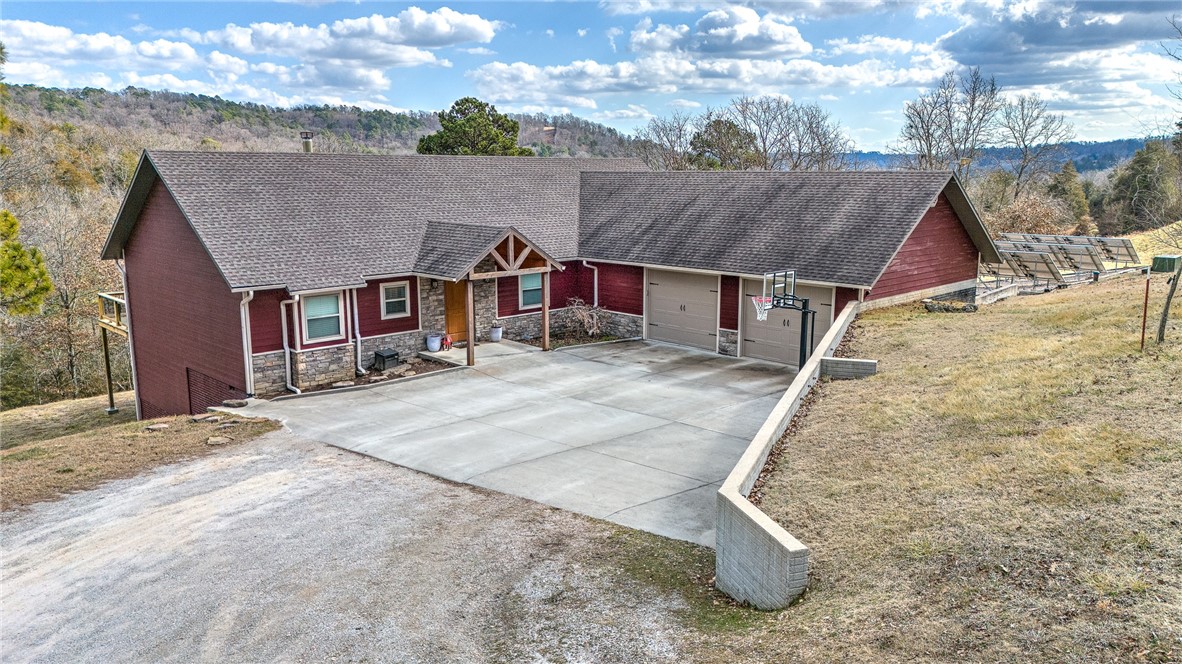 Secluded yet close to it all. This well-maintained property with no restrictions features 8 manicured acres, a 3,211 sq. ft. home with 5 bedrooms and 3.5 bathrooms as well as a barndominium that’s 40x60 with a fully furnished guest quarters or vacation rental for additional income. Spacious at 1,360 sq. ft. including 2 bedrooms and 1.5 bathrooms, new HVAC system. The property also includes a separate 40x50 workshop building. This contemporary home offers an aesthetically pleasing interior with beautiful hardwood floors, cathedral ceilings, stone fireplace insert, mudroom, kitchen island with breakfast bar, granite counter tops and stainless-steel appliances. The well-designed floor plan has spacious rooms, large primary suite with a large master bath including a double sink vanity, tile walk-in shower and dual closets. The expansive porch has a covered deck to enjoy the gorgeous Ozark Mountain views. 36 solar panels to supplement electric usage cost and stocked pond for fishing. Must see to appreciate.