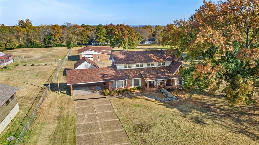 Beautiful, well-maintained home on 4.16 flat, cleared acres just 5 minutes from UA Fort Smith! This spacious property features a HUGE upstairs bonus room spanning the length of the house, perfect for a game room, studio, or extra living space. Enjoy both formal and informal living areas, plus a large kitchen and main-level bedrooms. Washer, dryer, and refrigerator all convey. Outside, a massive 2,590 sq ft brick shop with multiple bays and a full bathroom offers endless possibilities for hobbies, storage, or work. A rare find with room to grow!  New roofs on all buildings in 2023, Water heater replaced in 2023.