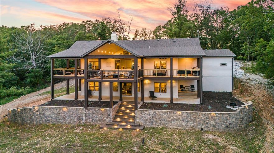 AirBNB ready!! This stunning 2019 lake home nestled atop 7.76 acres offers a breathtaking view of Beaver Lake. You'll enjoy lake living to the fullest with two 10 x 28 slips in a co-owned, solar powered dock with lifts and oversized swim deck. There's pleny of room for the toys in the 30 x 40 shop with 10 x 40 lean-to. A whole-home backup generator affords all the joys of quiet country living without the inconvenience of ever having a power outage. Inside, you'll appreciate high ceilings, a formal study, tile flooring throughout, a cozy wood-burning fireplace, high-end GE stainless appliance package including an Advantium Oven/Microwave combo, beauitiful honed granite counters, amazing master shower with rain head, body jets & hand-held spray wand, two guest bedrooms with en-suite baths, and a bonus room perfect for your home gym or media room. Boat, seadoos, tractor, side by side, and furnishings also for sale. Schedule your private showing today and start enjoying life on beatuiful Beaver Lake!