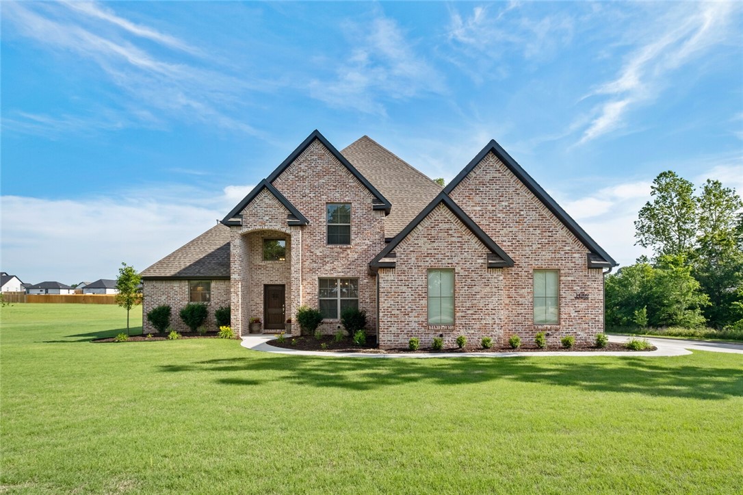 This stunning 5 bed, 3 bath custom home will take your breath away! Located 20 minutes from Springdale and Bentonville, this 1-acre corner lot is in a highly-desirable neighborhood. The beautiful brick is reclaimed from a Tennessee distillery and as you enter this home you are greeted with a 2-story entry, and a formal dining room with wood paneled ceilings. The open living room features custom built-ins on either side of the fireplace and the chefās kitchen boasts matching stainless-steel appliances, custom cabinetry, and quartz countertops. The main floor also features the spacious master bedroom and the striking master bath including a soaking tub and a HUGE walk-through shower. This split floor plan has a mother-in-law suite, laundry room, built-in work station and a mudroom to finish off the main floor. The upstairs addsĀ aĀ largeĀ entertainment room with bead-boarded walls, 2 bedrooms with a Jack & Jill bath and a mechanical room. The backyard features a covered patio and plenty of room to build a shop or pool.