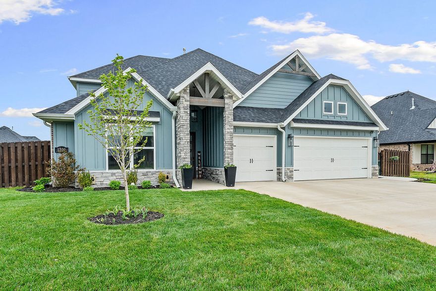 Welcome to 1200 Montieri Dr in Centerton—where modern design meets everyday functionality. Built in 2024, this beautifully crafted 4-bedroom, 3.5-bath home offers 3,001 square feet of thoughtfully designed living space.
At the heart of the home, the large kitchen is a true standout—featuring ample counter space, perfect for meal prep and gathering. The spacious layout is ideal for both daily living and entertaining. Main level features a private primary suite along with guest bedroom—both offering their own ensuite bathrooms. Upstairs, you’ll find two additional bedrooms, full bath and versatile game room—perfect for second living space, playroom or media area. Enjoy year-round outdoor living on the screened-in patio, complete with cozy fireplace, while the full irrigation system keeps both front and backyard looking lush with ease. The home also features a garage equipped with an EV charger, offering convenience for modern lifestyles. Move-in ready and loaded with upgrades, this is one you don’t want to miss.