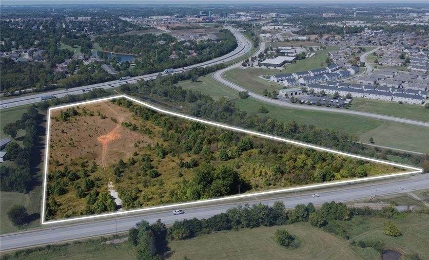 Prime development opportunity in one of Northwest Arkansas’s fastest-growing corridors.
This ±13.93-acre site, offered at $5,900,000 ($423,546 per acre | $9.72 per SF), is ideally
located at the intersection of S 26th Street and Interstate 49 in Rogers—adjacent to A.G.
Russell Knives with 80,000 vehicles per day on I-49. The property features T5.1 zoning,
which allows for a wide mix of uses including commercial, office, and higher-density
residential—promoting walkable, mixed-use development consistent with Rogers’ long-term
urban vision. Positioned less than one mile from Interstate-49 and just one exit (2.0 miles)
from the Pinnacle Hills area, the site is surrounded by a rapidly expanding network of new
residential communities, retail centers, restaurants, and service amenities. With exceptional
accessibility and visibility, this site presents an outstanding opportunity for developers and
investors seeking a dynamic location within the heart of Rogers’ growth corridor.