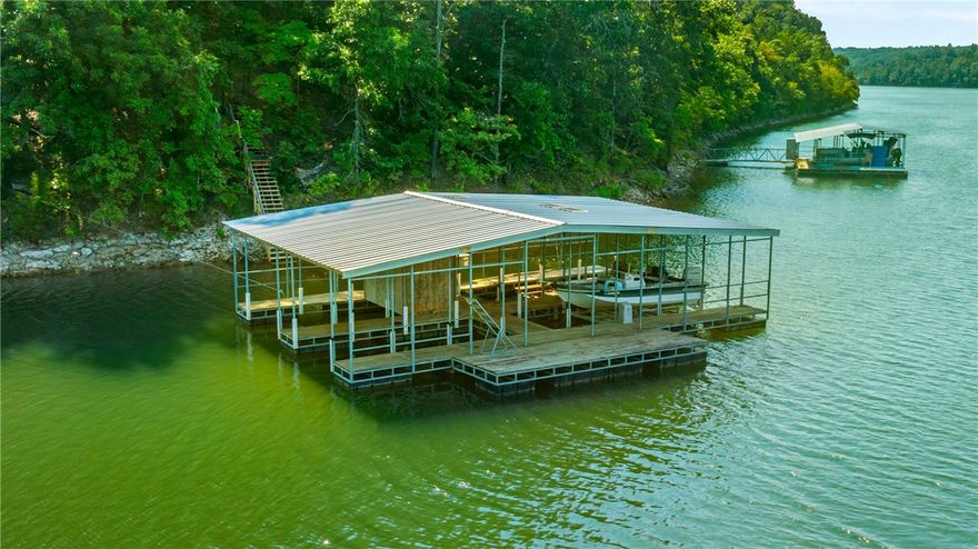 RARE Beaver Lake Retreat with It ALL! 2018 Custom-built on 11.87 Private acres with Yr. Round LAKE VIEWS. This LAKEFRONT property offers 2 Boat Slips on a Private Co-Owned Dock, a Guest House, and Shop, NO restrictions, endless opportunities. Designed for entertaining and everyday living, the open floorplan features a gourmet kitchen with expansive island and seamless flow to a screened-in patio overlooking the lake. The main level has STUNNING lake views from all of the living areas, includes a spa-like primary suite, two additional bedrooms, media room, and office space. The walk-out lower level boasts a huge bonus room, additional bedroom, and full bath. An 820-sq-ft Guest House with full kitchen, living room, 2BR and full bath is perfect for guests, in-laws, or rental income. The dock, 2 slips, oversized locker, and swim platform with easy access by side-by-side or SUV, The ultimate setting for lake days, sunset cruises, and unforgettable memories with family and friends. Call Agent full list of upgrades.