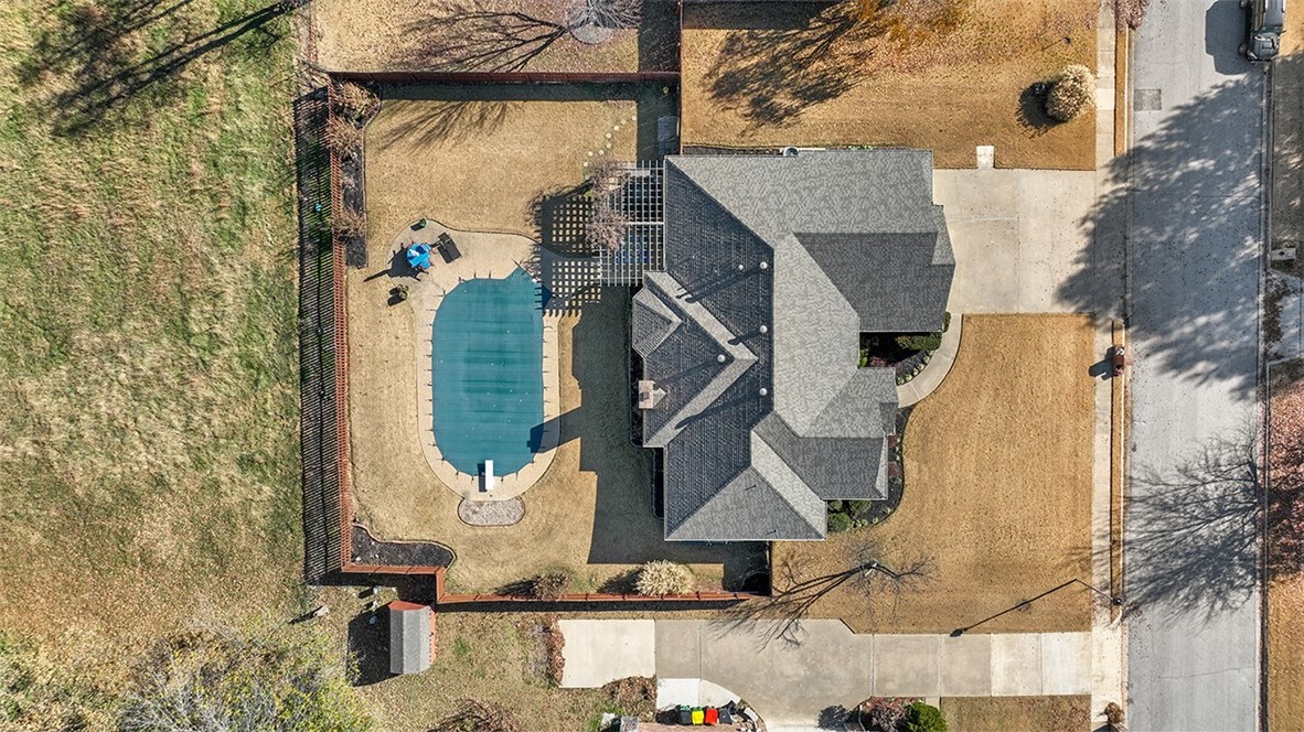 Open house Sunday 2:00-4:00. The vibrant colors of autumn make this meticulously maintained home spring to the top of your house hunting list. With a sprawling 30 acre field on the other side of the back fence, you will be able to swim in the inground pool in privacy. The location right off the Wagon Wheel exit is wildly convenient to everything NWA has to offer while also situated in the Har-Ber school system. These homeowners took pride in their home and it shows. Take a look at the pictures to see the split floor plan that includes 4 bedrooms, 2.5 bathrooms, a dining room, and large kitchen. And don't miss the top of the line Lutron Automatic Shades throughout the home (controlled by remote or phone). New items include: roof 2022, HVAC 2021, all windows including a frameless picture window in the kitchen 2021, exterior doors, LED lighting, and more. Plus top it all off with plenty of space in the three car garage with high quality epoxy flooring. This one is a treat! Go see it today. Video available also