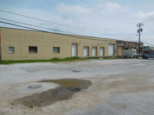 Commercial building @great price suitable for many uses. Subdivided into two areas. Smaller space (2400 sq. ft.) is currently leased for retail for $375 per month. Larger space (4,000 sq. ft.) was last rented for $600/per mo. (3)6'W x 8'H roll up doors & (2)10'4''W x 12'H roll up doors. Each side has 1/2 bath.
