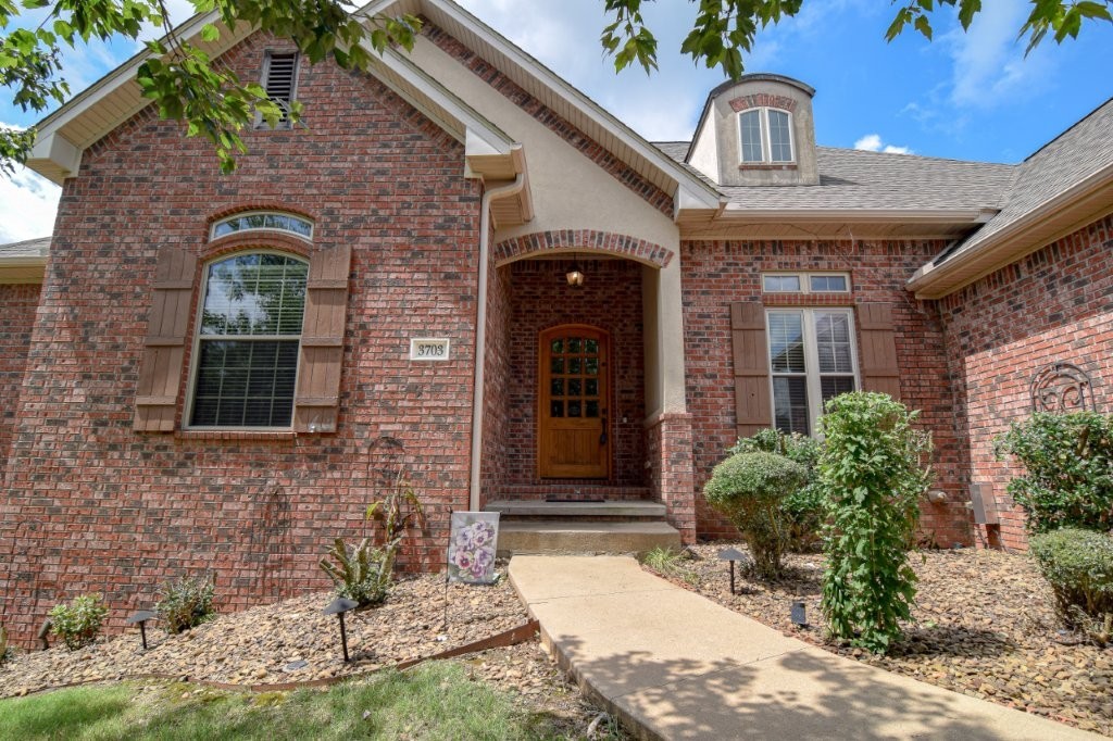 Stunning 5 bed Executive home in coveted Windemere Woods offers 4,008 SF of beautifully designed space. Enjoy fireside evenings in a spacious living room or morning coffee on the covered balcony. Eat-in kitchen shines w/ newer appliances, reverse osmosis, & pantry with secure fob access. Soaring ceilings, hardwood floors, & natural light fill the main level that also features a formal dining room & dedicated office (or 6th BR). Split floor plan offers privacy for the primary ensuite, laundry room, half bath, 2 other bedrooms & full bath. Downstairs, discover a 2nd living area w/ surround sound, kitchenette, & beautiful, wooded view off the 16āx42ā deck! Two bedrooms share a Jack & Jill bath, plus a cedar closet, storage, & half bath. Every bedroom has a walk-in closet. Extras: 3-car garage, medical-grade furnace & humidifier, Ring system, & under-home storage. Includes a Bella Vista lot for full access to BVV amenities! Minutes to Slaughter Pen & Coler Preserve, Bella Vista & Dwtn Bentonville, Walmart HQ, & more.