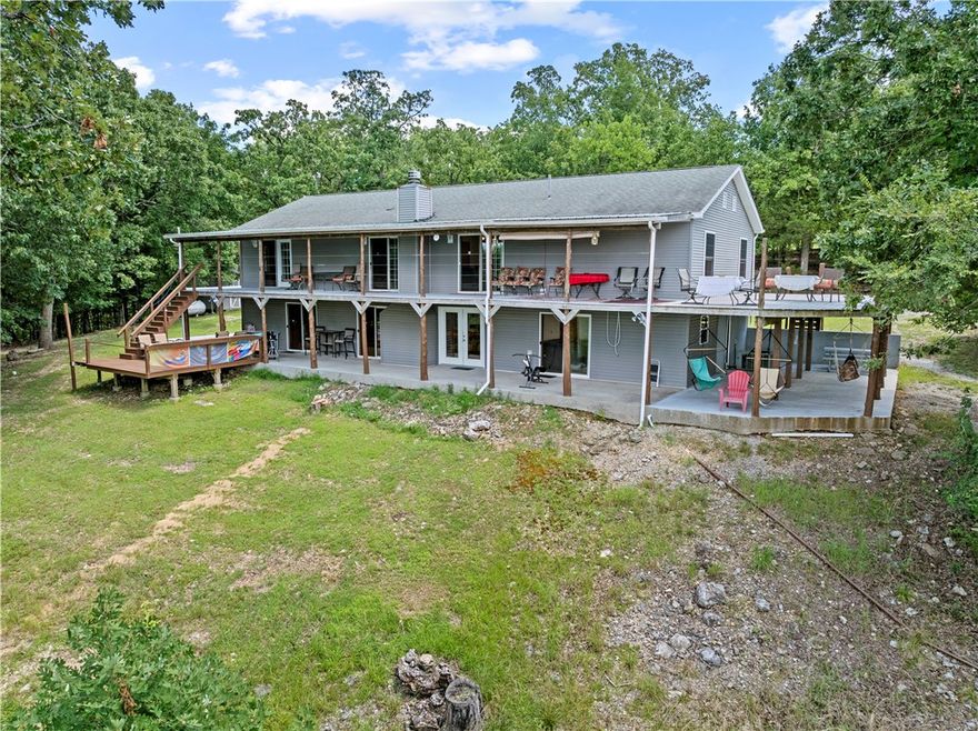 A rare opportunity—62± acres on a private peninsula, surrounded by Bull Shoals Lake on three sides. Unmatched privacy, panoramic views, & direct lake access set the stage for lake life at its best.

The fully furnished 3-bed, 3-bath home is made for relaxing & entertaining, with a wraparound deck. The walk-out basement offers a second living area, bonus room, storm shelter, kitchenette, & hot tub.

Your private two-stall dock with lifts conveys—a rare find on Bull Shoals, where no new dock permits are issued. Both boats can convey with an acceptable offer—lake days start instantly.

The land offers a mix of woods, clearings, trails, wildlife, & multiple build sites—perfect for a family retreat, vacation compound, or future development.

Extras: detached 2.5-car garage with studio apartment, carport for boat storage, & an outdoor shower.

Just 10 minutes from Lead Hill & 5 minutes from the nearest boat ramp at the end of Camp Galilee Rd (MC 2061). Secluded yet accessible—a legacy property like no other.