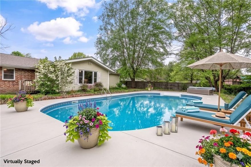 Exceptional 2,157 sq ft home sits on a spacious .46 acre lot, offering a perfect blend of privacy, convenience, & outdoor living. Enjoy a tranquil retreat with a 40x21 in-ground pool, positioned in an expansive backyard, that offers endless potential. Envision hosting gatherings, creating an outdoor kitchen, lounge area, & a garden oasis. Room for a play space or a guest house, the outdoor setting provides space & flexibility to bring your vision to life! Major updates include an new roof (2023), HVAC (2020), water heater (2021). A desirable 2nd living area (apx 2015) easily flows into an open kitchen, featuring granite counters & storage.  A wood-burning fireplace is located in the bonus living area, currently used as a primary retreat, great for relaxing at the end of the day. Conveniently located near I-49, you’ll enjoy both privacy & accessibility. Just 1.6 miles from JB Hunt Park, access to Spring Creek Trail, part of the Razorback Greenway. This location is a dream for outdoor enthusiasts & bike lovers alike.