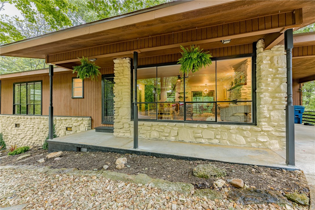 Custom Remodel with thoughtful preservation of the original home. Sleek modern bathrooms with stand-alone soaker tub. Open concept kitchen with custom butcher block island that's a perfect juxtaposition to the handcrafted concrete countertop. Mid-century light fixtures work in concert with large open windows to light a spacious living and dining area. Large forested lot with rock path leading to bike trail. Refrigerator, washer/dryer convey. Two-bedroom septic.