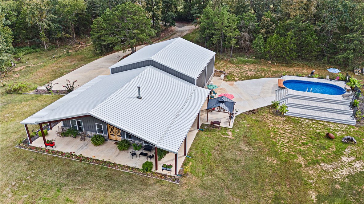 UNIQUE, RUSTIC- MEETS- INDUSTRIAL IN THIS PHENOMENAL NEWER BARNDOMINIUM! 5,600 sq ft of heated/cooled integrated living space, work place, and hobby arena. Only 3 years old, this secluded, stunning, creation sits on 10 acres more or less. Mountain views, close proximity to the national forest, mountain biking trails, and lakes. Breathtaking views, huge, covered porches on the exterior. The interior of the home portion has exquisite details in every square foot. All appliances convey. The home is approx 1900 sq. ft with the massive garage and shop hosting the remainder of 5600 sq feet. Shop has a half bath. Shop and garage have their own mini split systems. Built to withstand wind velocity of 115 mph (per seller), all windows, doors, skylights, and other covered openings were designed to withstand the specified wind loads. Every room offers high customization. The creek meanders through the north portion of this acreage. More acreage available-call for details. Additional acreage offers a pond and more of the creek.