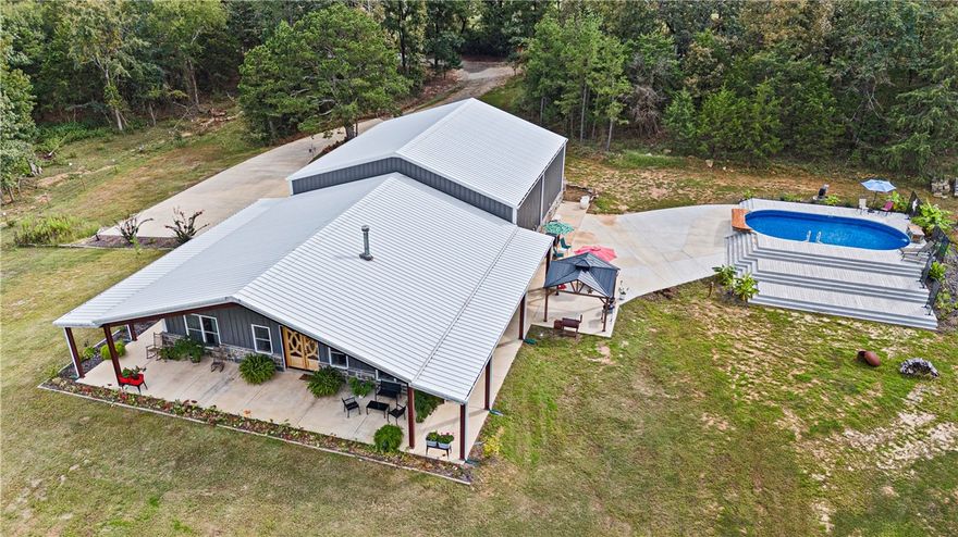UNIQUE, RUSTIC- MEETS- INDUSTRIAL IN THIS PHENOMENAL NEWER BARNDOMINIUM! 5,600 sq ft of heated/cooled integrated living space, work place, and hobby arena. Only 3 years old, this secluded, stunning, creation sits on 10 acres more or less. Mountain views, close proximity to the national forest, mountain biking trails, and lakes. Breathtaking views, huge, covered porches on the exterior. The interior of the home portion has exquisite details in every square foot. All appliances convey. The home is approx 1900 sq. ft with the massive garage and shop hosting the remainder of 5600 sq feet. Shop has a half bath. Shop and garage have their own mini split systems. Built to withstand wind velocity of 115 mph (per seller), all windows, doors, skylights, and other covered openings were designed to withstand the specified wind loads. Every room offers high customization. The creek meanders through the north portion of this acreage. More acreage available-call for details. Additional acreage offers a pond and more of the creek.