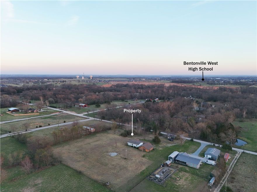 2.81 acres with no covenants or restrictions in a fast-growing area of Northwest Arkansas—this is the land opportunity you’ve been waiting for. Located just 4 minutes to I-49, 8 minutes to Bentonville West High School, and 16 minutes to the new Walmart Campus.

Selling as land only, as-is. Existing manufactured home, detached garage, and storage building convey with no value.

Utilities are already in place with water and electric on site, plus an existing septic system for a 3-bedroom home—saving time and upfront costs. Whether you're looking to build, invest, or hold, this property offers flexibility and strong upside potential.