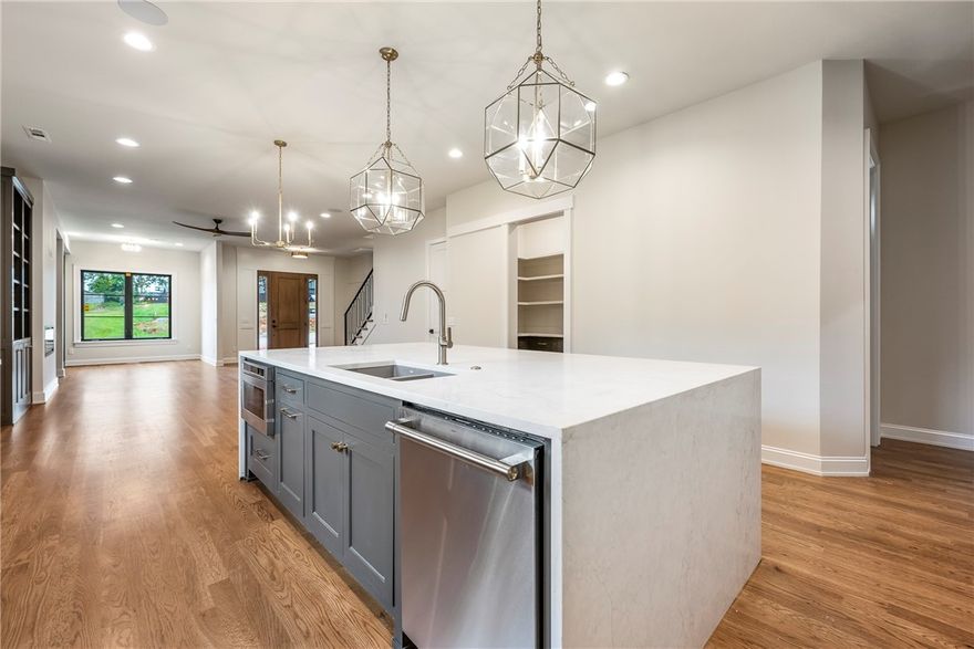 Welcome to Charming Manor where traditional charm meets modern comfort. This townhome features 
site-finished wood floors, a reading/music nook, and special craftsmanship features throughout. Enjoy your morning coffee on your private primary suite deck. Love to entertain? The large bonus room opens up to the 3rd story outdoor patio that overlooks Park Springs Park. Enjoy mountain biking or walking the trails? The Park Springs Trailhead is steps from your door. walking distance to Downtown Bentonville’s restaurants, shops, and Crystal Bridges—this home brings together luxury living and the best of Bentonville’s outdoor lifestyle. taxes based on land and subject to change. Up to $5,000 in lender credits with preferred lender- preferred lender is Valerie Kurbis at AMC Mortgage.