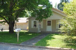 Wonderful older home with lots of charm & character. 2 bedrooms, 1 bath with spacious closets. Separate laundry room, two garages and a spacious sunroom. All of this on just under an acre in town.