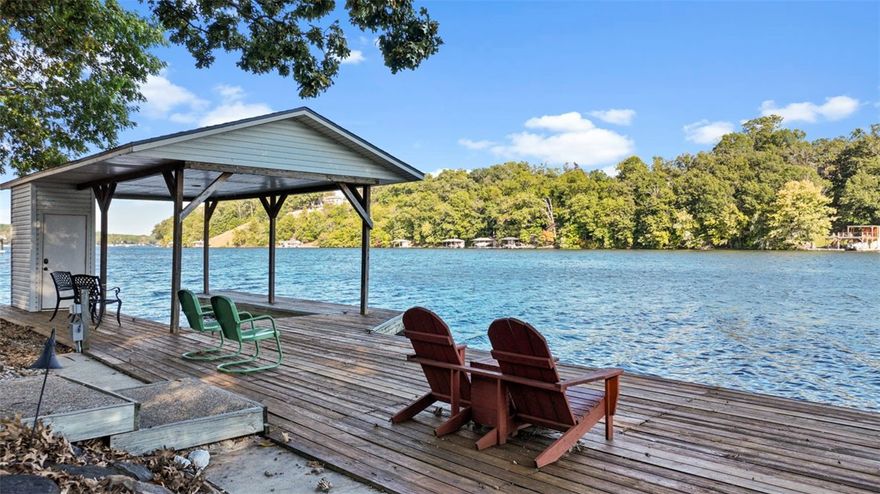 Welcome home to lakefront living on Loch Lomond, Bella Vista's largest private lake! Step inside & feel the Ozark vibe of this spacious home with wide views of the lake and the great outdoors. This home offers an expansive kitchen with tons of storage, large utility room, 3 living areas with 3BR/2FB upstairs, 1BR/1FB and living area downstairs. The screened-in porch will be a favorite place to relax and take in all the sights and sounds of the Ozarks. Downstairs has a walk-out leading to a large covered patio. Indoor access to a huge, encapsulated storage area, along with a workshop for the DIY'er. Access to the private dock is an easy 20 steps down! The location of this home gets 5 stars! Shade on the dock by noon, less busy area of the lake, on a quiet cul-de-sac with a tree covered ravine on one side creating a sense of ultimate peacefulness. Only minutes drive to I-49, trails, museums and all NWA has to offer! New roof, gutters, seawall, carpeting (upstairs), LVP flooring installed 2021. Septic flushed 2021.