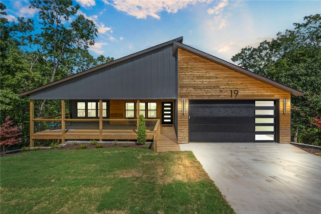 This newly built contemporary home truly has it allācentral location close to everything in Bella Vista, thoughtfully designed with sleek modern finishes, all on a private wooded lot. But what really makes this home special are the 2 enormous decks that truly extend your living space outdoors. This 3 bed/2 bath home is located near Lake Loch Lomond and the Branchwood Rec. Complex. Thoughtfully designed details set this home apart: spacious kitchen with quartz countertops, waterfall island, and abundant storage; stone fireplace and modern lighting; spacious bedrooms with oversized closets; and walls of windows filling the home with natural light and forest views. The exterior features Hardie siding with cedar accents, sleek cable railing, a spacious front porch, & an expanded back deck. Whether inside or outside, you'll never get tired of the private Ozark views that surround you! All this in the heart of Bella Vistaājust minutes from 9 golf courses, 7 lakes, and 100+ miles of trails. Agent is related to seller.