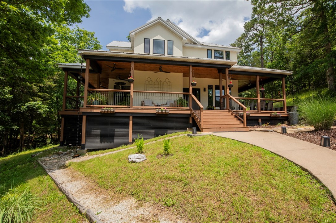 Discover the perfect blend of privacy, convenience, and upscale living in this newly remodeled home, nestled on approximately 4 wooded acres and accessible only through a private, gated road. Located just minutes from town, this peaceful retreat offers the best of both worlds—total seclusion with easy access to modern amenities. The home features new James Hardie cement siding and a spacious wrap-around covered front porch, complete with an outdoor fireplace, perfect for year-round entertaining or quiet evenings surrounded by nature. A fenced garden area adds charm and practicality for green thumbs. Inside, you'll find a thoughtfully designed layout with high-end finishes throughout. The gourmet kitchen boasts quartz countertops, double ovens, a gas range, and a wine fridge—ideal for cooking & entertaining. The master suite offers a spa-like experience with a luxurious steam shower. A major bonus is the impressive 36'x60' shop.