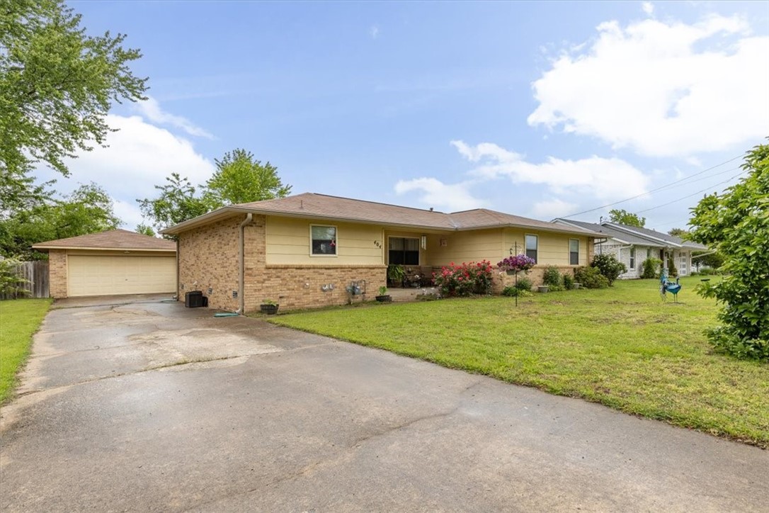 One level home in Bentonville just off of Walton Blvd. with an easy walk to Osage Park. Detached two car garage with covered overhang, perfect for boat storage. Huge privacy fenced yard. Open floor plan with large pantry, ample counter space, and formal dining! The primary suite is huge with plenty of room to expand the primary bath if desired! Carpet free with LVP flooring in main living areas. This home offers many options to various buyers in the Bentonville market! Sold AS-IS.