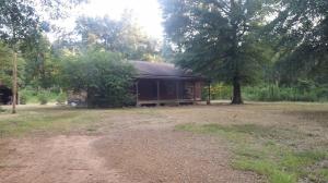 If your dream has been a cabin in the woods, you have found it. Sitting on 3.4 +/- acres with storage and out buildings is this spacious 2 bedroom 1 bath cabin inviting you to sit and sip on the open front porch. Property is Bank Owned and is sold AS IS, WHERE IS. No warranties implied or expressed. Great home for the money.