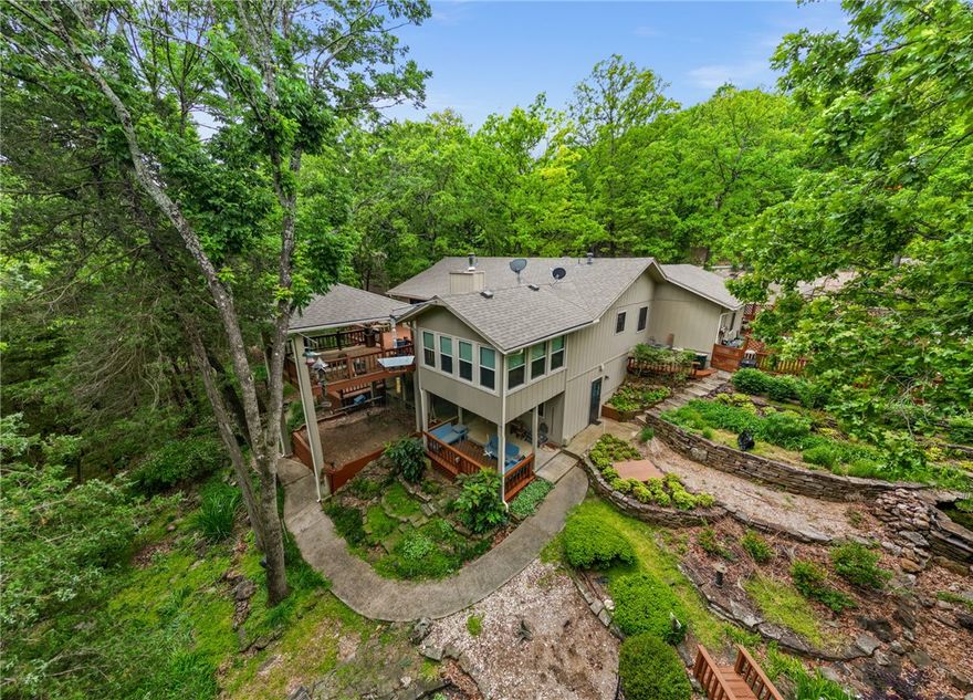 Experience the best of lake living in this beautifully maintained 3 bedroom, 2.5 bath lakefront home in Lost Bridge Village.  This inviting property features a 2 car garage plus a 2 car detached garage.  Enjoy outdoor living at its finest with two levels of spacious decking overlooking the natural surroundings, along with a charming gazebo ideal for entertaining.  

The home is surrounded by extensive landscaping and thoughtfully designed raised bed gardens, creating a peaceful, park like setting.  A gentle, easy walk leads you straight to the lake.  Inside and out, this home has been exceptionally well cared for, offering a move-in ready retreat.  

Located in a desirable community with amenities including a pool and pickleball court, this property combines comfort, convenience, and the ultimate lakefront lifestyle.   Whether you are looking for a full time residence or weekend escape, this Beaver Lake gem delivers!