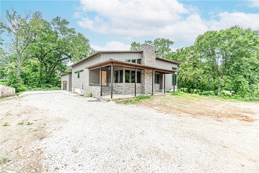 Newly-built smart home just blocks from Downtown Bentonville and Compton Gardens! This modern 2022 build sits on a spacious 0.6 acre lot and showcases modern architecture with exterior rock accents and a spacious covered front porch. Step into this open concept, split floor plan layout featuring cathedral ceilings, an abundance of natural light, built in fireplace, and beautiful vinyl flooring throughout. You’ll enjoy preparing meals in this chef's kitchen boasting an oversized island, granite countertops, and plenty of storage space. Entertain outside on your spacious covered patio with tv hookup and ceiling fans. The master suite boasts an ensuite bathroom complete with double vanity, large tiled shower, and roomy ensuite walk-in closets. There are endless possibilities to make this home your own with the current unfinished state of the 1423 sqft walk out basement. This one of a kind opportunity does not come along often! **Sold as is**
