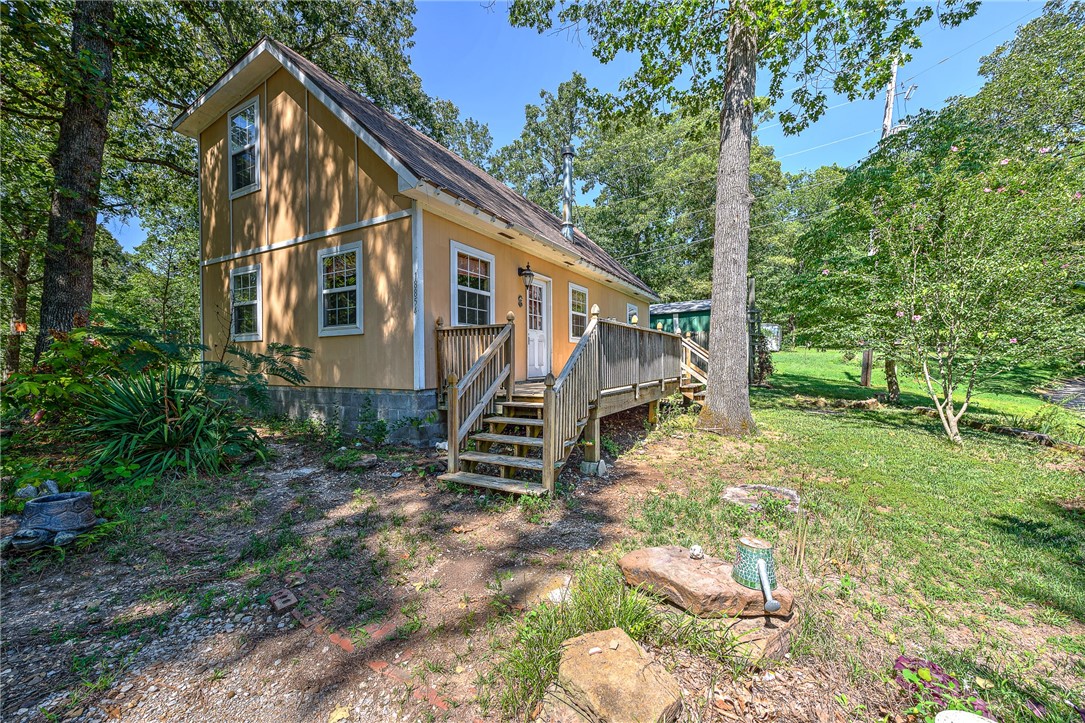 Country, peaceful living while also being close to the lake. The boat ramp is approx 1.2 miles away. Check out this cute cottage on a large lot. The living area is plumbed for a wood stove. The yard extends past the wood privacy fence and includes 2 storage buildings.