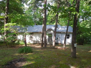 WOW..Reduced to 26,500!!What a pretty setting for this older cottage! Hwy frontage for this large tree shaded lot. The home needs work, and there is a barn/garage on the property that could be rehabbed also. Price is firm, and selling ''as is'' but this could really be a neat place with a little work! New survey just completed.