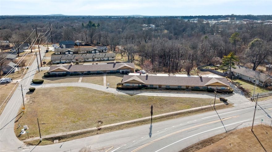 Fantastic investment opportunity!  Apartment complex consists of two buildings and eight separate units. Each apartment boasts approximately 1500 sq ft living space, two spacious bedrooms, one full and one half baths, full kitchen with dining area.  Every unit includes stove, dishwasher, water heater, washer and dryer hookup, and a large brick wood burning fireplace.  Each unit has its own private front and rear access with two vehicle carport covered parking.  Property sits on 2.63 acres with grassy common areas. Both buildings and  four shared storage sheds received new roofs in 2021.  Many updates to units made over time.  Each unit having recently received updated stoves and dishwashers.  Many HVAC units replaced over last several years.  Located just a few city blocks from historical downtown Rogers.  Sellers estimate a 90 occupancy rate over the last 10 years.  Please have pre-qualification or proof of funds available and attached to any offer. Allow for 72 hour response to any offers.