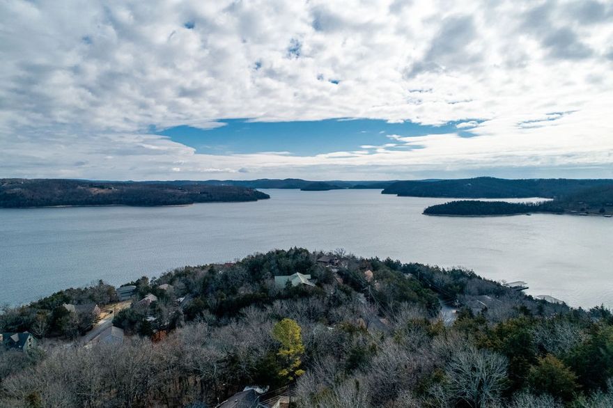 A stunning lakeview home with one of the best views from most every room you will ever see on Beaver Lake!  The main level floor plan includes an open plan with a chef’s kitchen, 2 bedrooms, a dedicated separate office and 2.5 baths.  The lower level includes an additional 2 bedrooms, a full bath and a  family room for entertainment!  Vast storage throughout the home includes a cedar lined closet and bonus storage areas.  The outdoor deck space to enjoy the 180* view has ample space for guests!  The sellers currently have a 26’ slip at Lost Bridge Marina and the slip may transfer with the sale (6400 lb lift not included, but may be negotiable). Too many updates to list (see attachment), Roof-2014, HVAC-2021, Hot Water-2019, fresh paint and more!  Most furnishings and boat may be available to purchase at an additional cost.  In addition, the sellers have had a great experience with this property as a short term rental.  Their guest list can convey and it could easily be a turn key income producing property.