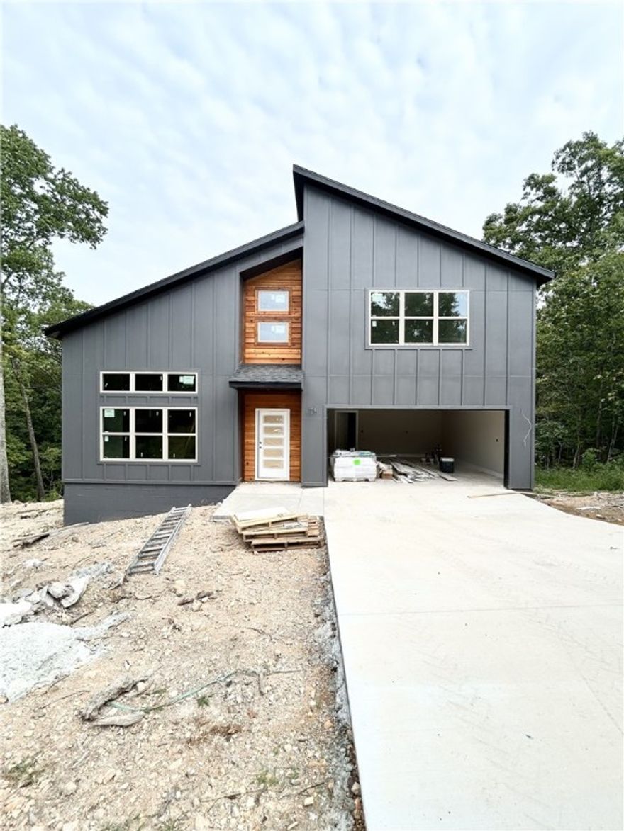 Check out this modern new construction home on a .33 acre wooded lot! Located just minutes from Lake Brittany and the Back 40! Bentonville schools! 3 bedrooms / 2.5 baths + bonus. Step into a bright and airy interior featuring tall ceilings and a striking 2-story fireplace. The kitchen boasts custom cabinets, gas range, and 3 cm quartz countertops. The primary bath features a luxurious soaking tub and a walk-in tile shower. Enjoy abundant natural light throughout, and entertain on the spacious deck overlooking the serene landscape. High-end finishes throughout. As an added bonus, receive $3,500 towards buyer's closing costs when working with the builder’s preferred local lender! Schedule your showing today!