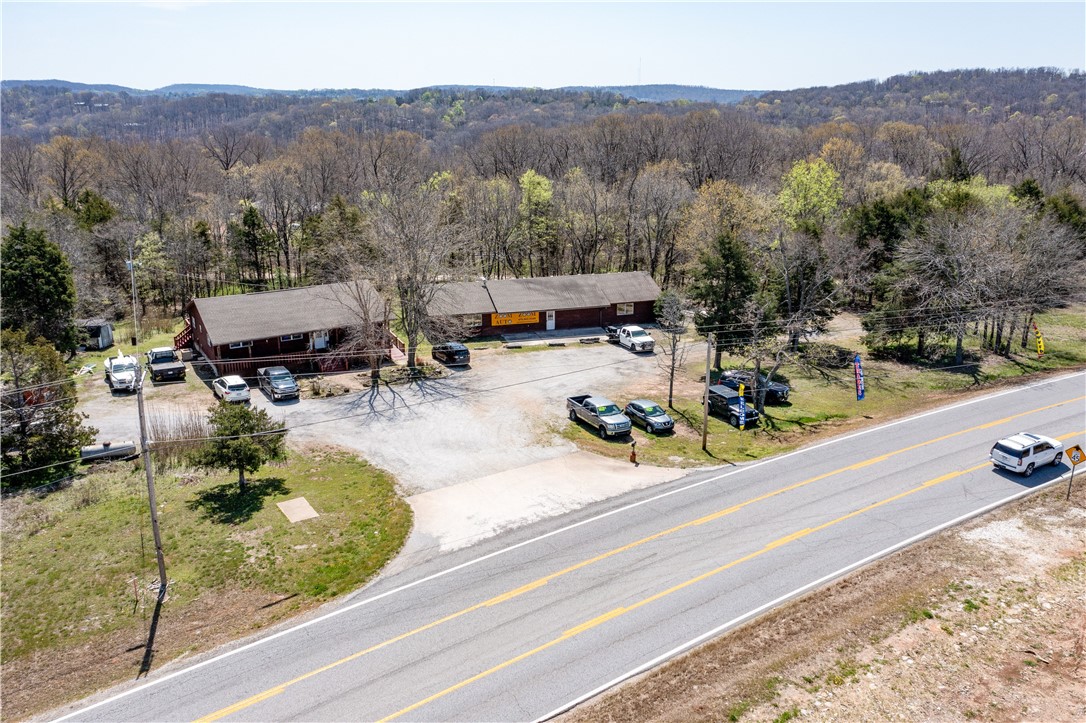 Seller would consider a potential leaseback option. Commercial property with ± 546 linear feet of frontage on Hwy 62 with great visibility. County road Roberts Loop runs through the back of the property. The road is maintained by Benton County. The property consists of an office (± 1,680 SF) and a shop/warehouse (± 2,640 SF). The property has city water, septic for sewer, and two 500-gallon propane tanks. New HVAC in the shop. The shop has a water tap ready to be set up for use.