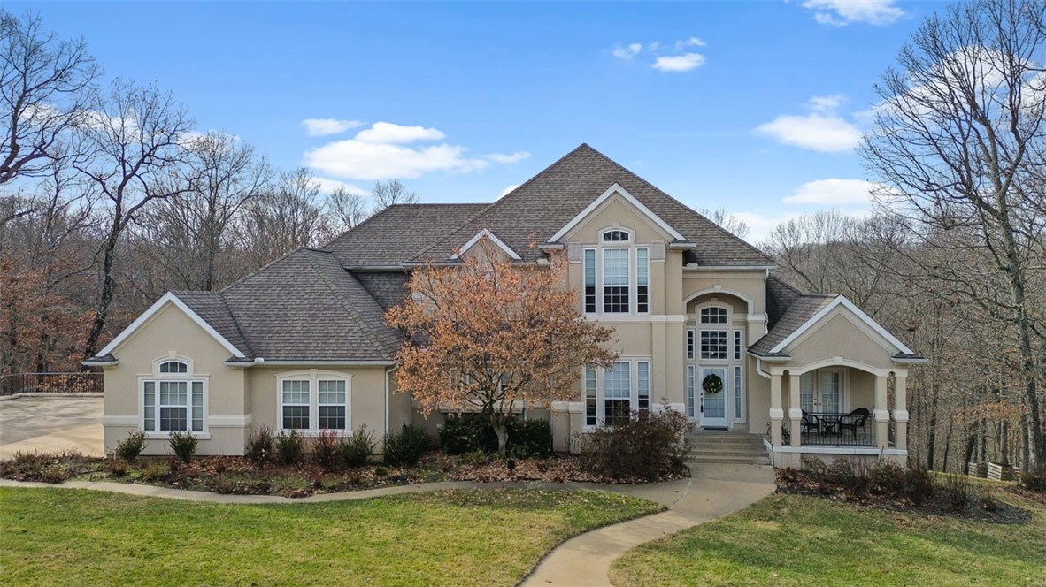 Welcome to your dream property nestled on a 1.79-acre lot at the end of a cul-de-sac. Conveniently located close to Lake Atalanta and a short drive to vibrant downtown Rogers. This 4 bed, 4.5 bath home also has an office with beautiful built-ins, an extra storage/workshop room downstairs with an overhead door, and a 4 car garage. The spacious living room features 18’ vaulted ceilings and large windows providing tons of natural light. Outside you’ll find the perfect spot for entertaining guests with an in-ground pool, hot tub, and privacy behind the property. Schedule your showing today!