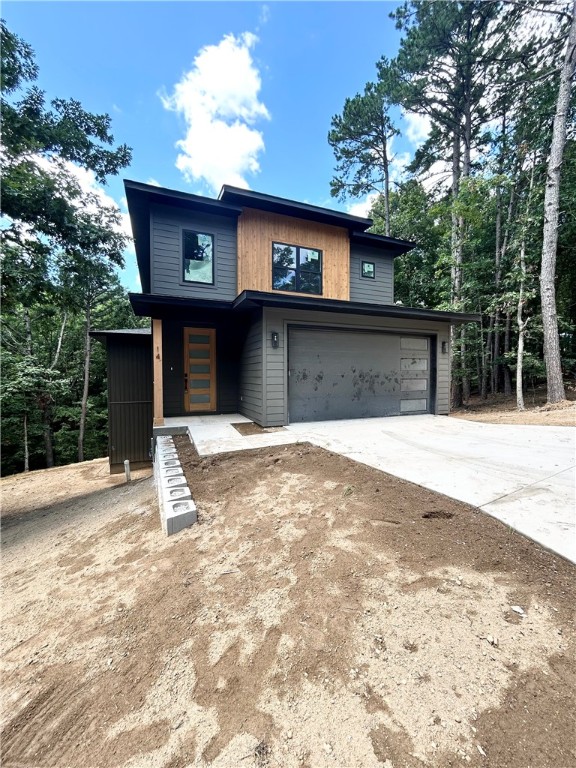 Introducing a stunning modern new construction home on a spacious .32-acre wooded lot, perfectly located near the Back 40 Trail Crossing, Lake Ann boat launch, and Lake Rayburn! As you enter through the impressive two-story entrance, youāll be greeted by an elegant living space with tons of natural light and a gas fireplace. The kitchen showcases high-end finishes, custom cabinets, and sleek 3 cm quartz countertops, complete with a gas range. The primary bath boasts a luxurious walk-in tile shower for a spa-like experience. No carpet! Step outside to the expansive deck, where you can soak in breathtaking views and enjoy outdoor living at its finest. This home offers a perfect blend of modern design and serene nature, making it an ideal retreat for those seeking luxury and convenience. Bentonville schools!
