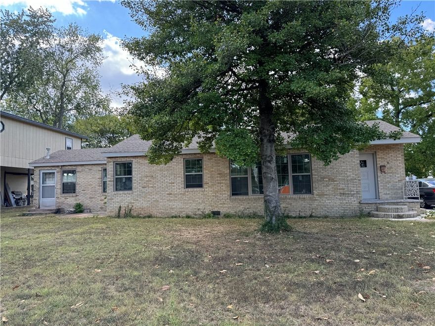 GREAT potential for commercial business on busy main road - Mount Olive St - thru the heart of Siloam Springs! Located across from the Siloam Food Court and commercial shopping center, this property sits on a large .33 acre +/- lot!  Also features a large detached building that is great for storage or additional work space/office space.  Home still needs some renovations but has recently had new double pane vinyl windows installed, new interior paint, and new carpet.  There are 4 total doors to the outside so could easily be separate access for rental spaces .. Located within walking distance to schools, downtown Siloam Springs, parks, etc and LESS THAN A MILE TO HWY 412! THIS PROPERTY IS NOT CURRENTLY ZONED COMMERCIAL.  Buyer needs to do Due Diligence for themselves with City of Siloam Springs.