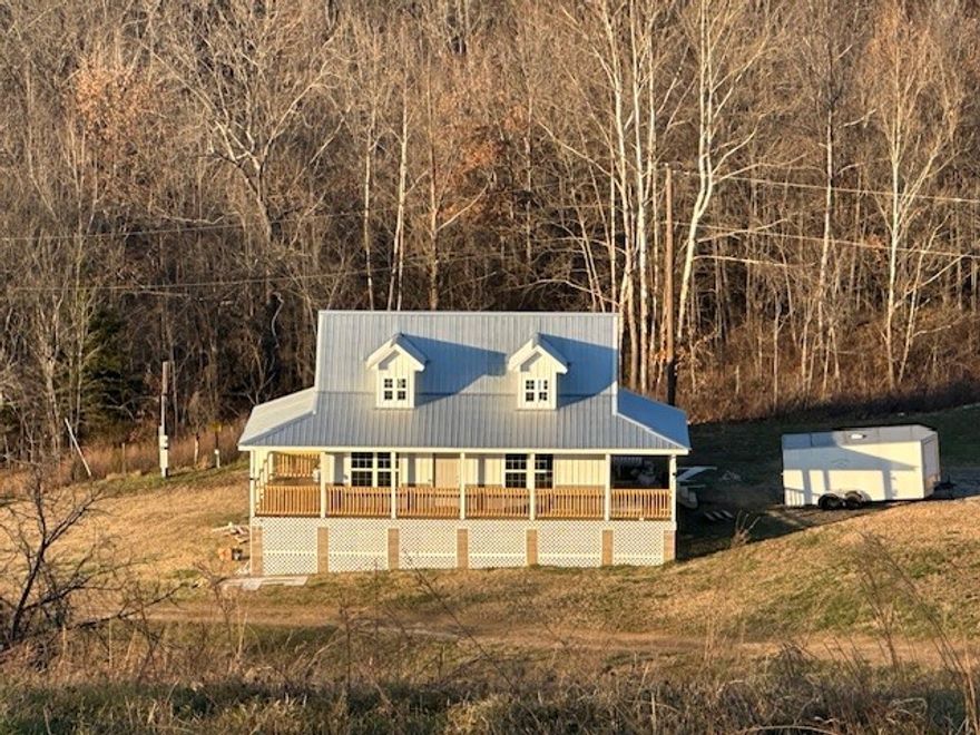 This unique 4 BR, 1 BA home (with soaker tub) offers 1344 sq ft of comfortable space with luxury vinyl plank flooring throughout. Plans are available to add a 2nd bathroom upstairs. Adjacent to the main home is a 38'x64' large workshop/motor home bldg with three 10 x 12 foot doors and one 12x14 ft door, housing a fully outfitted tiny home with 1 BR and 1.5 BA---perfect for guests or as rental potential. Powering this unique compound are 2 leased propane tanks---one 200 gallons, the other 330 gallons. A standout feature is a massive 52 ft diameter footprint excavated for a future round house, envisioned to rise 24 ft high.  The $23,000 pre-cut foam pieces will convey--making this the 3rd house on the property. The house features a spring-fed water system with a purification system, ensuring fresh clean water flows year-round. You'll also find not one, but two ponds, the larger, approximately 1.25 ac, is stocked with bass, crappie, minnows, blue gill, sun perch, and red ear. Peaceful living, room to grow and hunting!