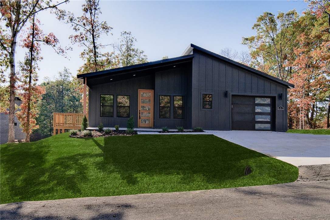 Discover this stunning modern new cons't home on a FLAT .29-acre wooded lot, just moments away from Lake Loch Lomond, Branchwood Recreation Center, Highlands Golf course, & I-49. This exquisite home boasts high-end finishes throughout, featuring a sleek hardie-board front exterior & striking black windows that perfectly compliment its contemporary design. Step inside to find a stylish open-concept layout, adorned with NO carpet. The focal point of the home is the kitchen, equipped with custom cabinets, a wood hood, & luxurious countertops. You'll love cooking with premium black stainless steel appliances, including a gas range. Retreat to the primary bath, where you'll find a spacious walk-in tile shower & double vanity. Completion date - 9/8/25
**Pics may not be of exact unit. Colors/finishes may vary**