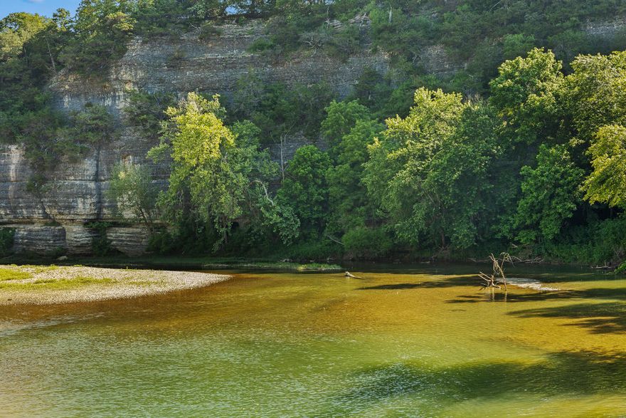 Discover your pristine waterfront farm in Carroll County, AR. This stunning property boasts over a mile of Long Creek frontage, offering a charming farmhouse and numerous prime building sites for your dream home. With approximately 90% of the land in open pasture, two well-maintained hayfields, and several ponds, it is ideal for haying and running cattle. Recent improvements include extensive dozer work and nearly one mile of brand-new 6-strand barb wire fencing. Large mature timber and breathtaking views of the Ozark Mountains add to the property's natural beauty. Abundant wildlife, including large whitetail bucks and turkeys, make this area a paradise for nature lovers and hunters. Explore the gorgeous bluffs and serene landscapes of this North Arkansas masterpiece.