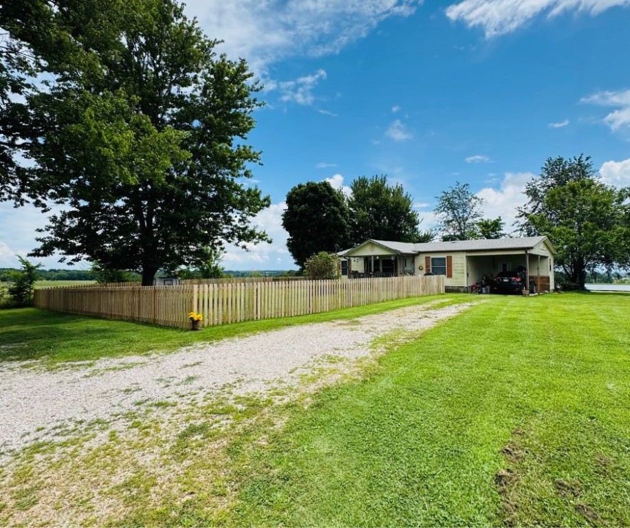 Beautifully remodeled 3-bedroom, 2-bath manufactured home on 0.5 acres along Clifty Highway near Huntsville. Built in 1991 and offering 1,064 heated square feet, this home has been thoughtfully updated with new luxury vinyl plank flooring, fresh paint, modern light fixtures, updated bathrooms, and all-new plumbing. The kitchen features updated cabinets, a gas range and oven, dishwasher, refrigerator, and vent hood. A newer architectural shingle roof (3 years old), central air conditioning, and propane heat provide both comfort and efficiency. Additional amenities include ceiling fans, washer/dryer hookups, and an attached one-car carport. Located just 15 minutes from Huntsville and within easy reach of Eureka Springs, this move-in ready home is ideal for buyers seeking quality, convenience, and modern upgrades in a rural setting. Home with additional 5.36 acres is sold together MLS listing 1314697