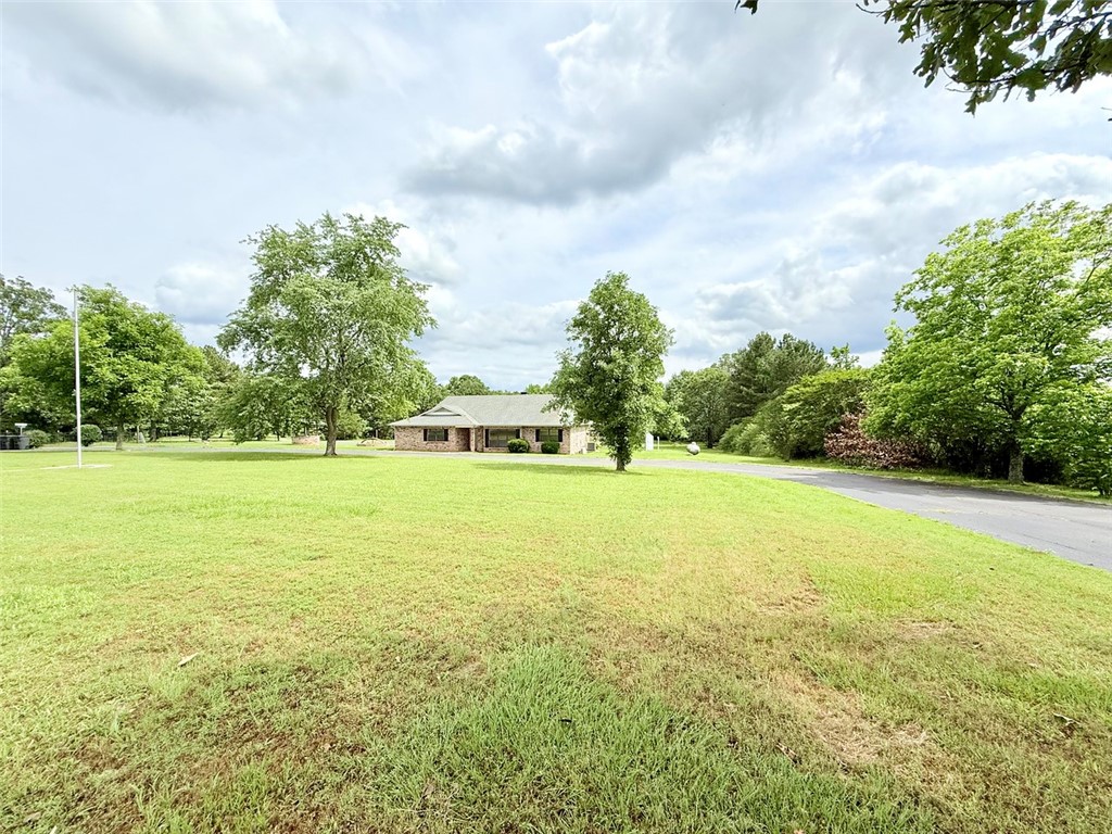 Discover this beautifully updated 3-bedroom, 3-bath home on 6.60 acres in Dover! Offers two spacious living areas, a cozy fireplace, and large windows for natural light. The kitchen features brand-new countertops, freshly painted cabinets, and opens to a dining area perfect for family meals. Enjoy new flooring and paint throughout, a laundry room with built-in storage, and a full bathroom just off the garage. Step into the sunroom that leads out to a large back deck—ideal for relaxing or entertaining. A portion of the yard is fully fenced, perfect for pets, and connects via a paved walkway to the heated and cooled detached 2-car garage/shop, which includes its own full bathroom and could easily be converted into a guest suite or workshop. There is an oversized shed, covered back patio, and whole-house generator for peace of mind. A creek runs along the back of the property, and a paved circle driveway offers plenty of parking. This one checks all the boxes space, updates, and functionality. See private remarks.