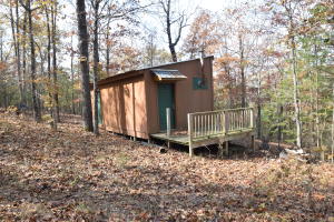 An opportunity to be ''off the grid'' with shelter already on site. Private camping at its best. Near Crooked Creek-Described as ''the blue-ribbon smallmouth stream of the state,'' https://www.arkansas.com/river/crooked-creek/24. Electric transformer and phone is across the road. Buyer to verify any utility availability.