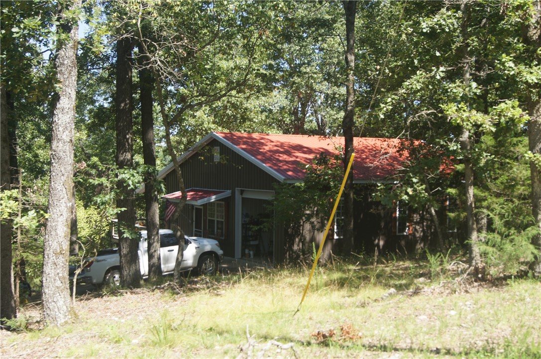 Quaint two bedroom one bath (cabin - minimum) with two large doors and 560sqft of garage/shop space. Pull your boat in and unhitch. Inside is an open living area and kitchen with two split bedrooms and one bath. Very low maintenance with metal and frame construction. Winter lake view with a two stall private dock & lift. Not many around the lake like this. Also includes PID #18-04908-002 (.85/ac) for a total of 3 lake front acres.