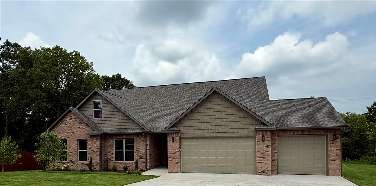 NEW TOP QUALITY BELLA VISTA HOME FROM EXCEPTIONAL BUILDER! This thoughtfully designed 3-bedroom, 3-bath residence showcases a light and spacious kitchen with quartz countertops, custom built cabinets and a large walk-in pantry.
Enjoy a great room with 11’ ceiling and a unique stone fireplace - perfect for cozy evenings and entertaining. By day, oversized, energy-saving windows illuminate the home with natural light. The main bedroom suite includes a walk-in closet and a bath with double vanity, custom tile shower and soaker tub. Also on the first floor are two other bedrooms and a full guest bath with double vanity and shower/tub. The second floor offers a huge bonus room with lots of light and 3/4 bath with shower. The walk-in attic is floored and ready to use!
Large, covered deck is ideal for gatherings with family and friends, and home has a three car garage.