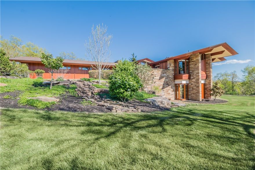 This piece of Mid-Century modern art is truly one-of-a-kind. Inspired and trained by Fay Jones, this masterpiece was custom designed by renowned local architect, David W. McKee. Perfectly integrated into the hillside, this home emphasizes natural materials, a close relationship to the landscape, and easy movement from one space into another. The brilliant 6,218 sq. ft. design creates open living spaces that are perfectly utilized. A pristine indoor lap pool with full-length skylights and a wall of accordion glass doors further enhance the home’s connection to the landscape. Located on the main level, the master wing is breathtaking, featuring a private sitting room, a light filled bedroom and a gorgeous bathroom that make you feel one with nature. The lower level is complete with the guest quarters, an entertainment space and exercise room. Every detail of this home was carefully considered and meticulously built to create a serene, luxurious retreat.