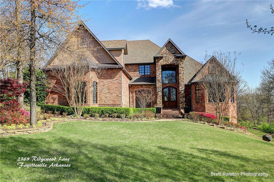 Amazing Estate home bordering the beautiful Ozark natural landscape! With Three levels including a finished walk out basement with full bath, bar, & storage room. Handscraped Wood floors, walk in closets, All Kitchen appliances are commercial grade, stainless, three distinct living areas, two gas & wood burning fireplaces, Custom cabinets, granite countertops throughout, customized office & laundry room, walk in pantry, Butler’s pantry,&covered patio. Too many features to list! Located minutes from Uptown